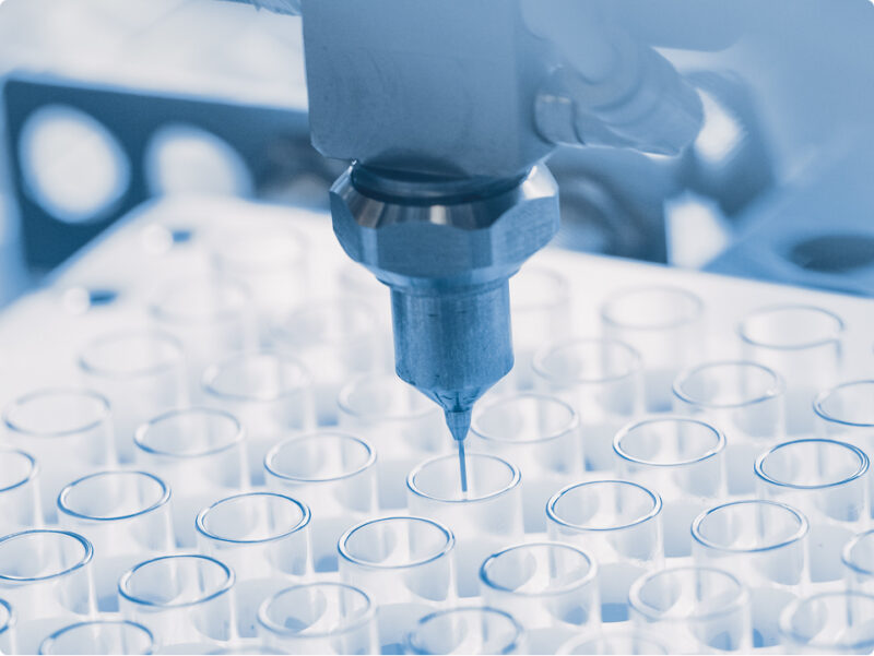 Pipette füllt Flüssigkeit in Probenröhrchen im Labor